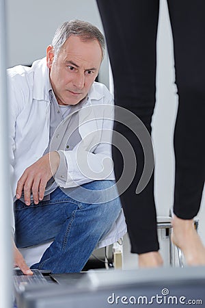 Doctor observing woman on treadmill Stock Photo