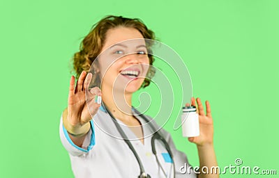 Doctor is offering to drug tablet. introducing the properties of the painkiller. Female doctor gives jar of pills to Stock Photo