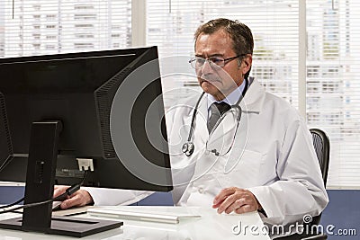 Doctor in office using computer, horizontal Stock Photo