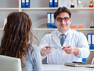 Doctor optician prescribing glasses to a patient Stock Photo