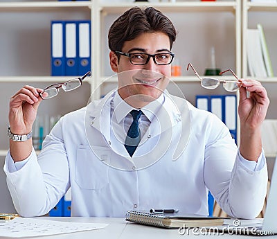 The doctor optician prescribing holding optical glasses Stock Photo