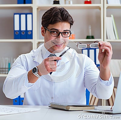 Doctor optician prescribing holding optical glasses Stock Photo