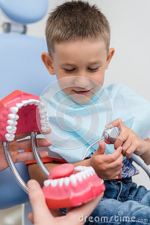Doctor orthodontist playing with the boy in the dental office Stock Photo