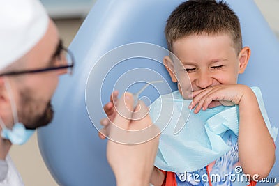 Doctor orthodontist playing with the boy in the dental office Stock Photo