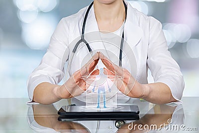 A doctor palms in protection position under the human figure model Stock Photo