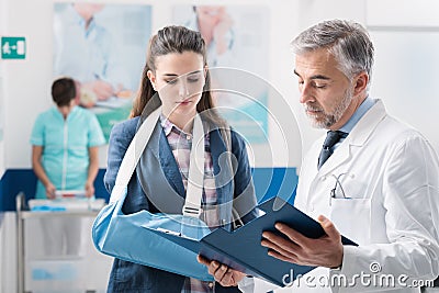 Doctor with a patient with broken arm Stock Photo