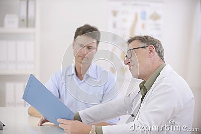 Doctor and patient discussing blood-test results Stock Photo