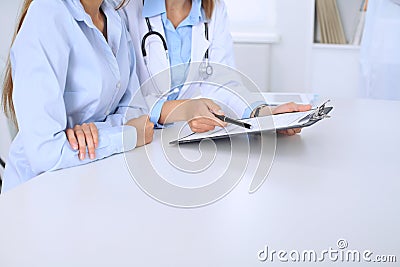 Doctor and patient are discussing something. Physician pointing into medical history Stock Photo