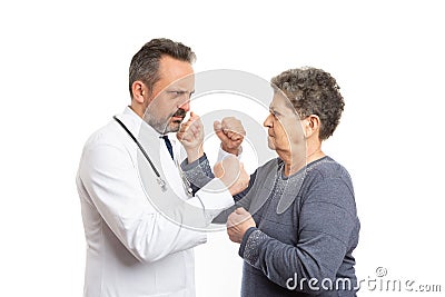 Doctor and patient fighting with fists Stock Photo