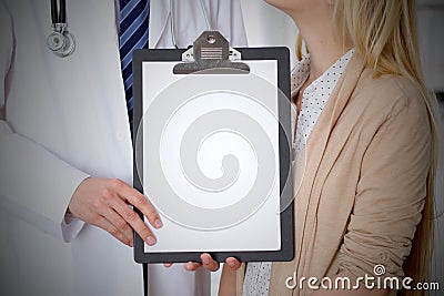 Doctor and patient holding clipboard free copy space. Medical ethics and trust concept Stock Photo