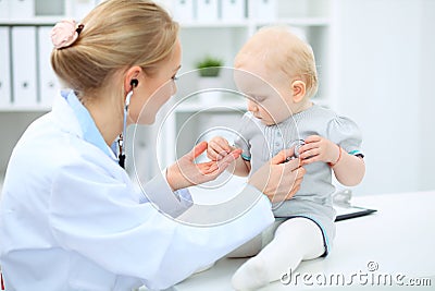 Doctor and patient in hospital. Little girl is being examined by pediatrician with stethoscope. Medicine and health care Stock Photo