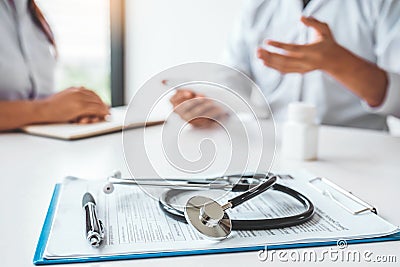 Doctor with patient presenting about Treatment guidelines on digital tablet at office Stock Photo