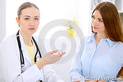 Doctor and patient sitting at the desk near window Stock Photo