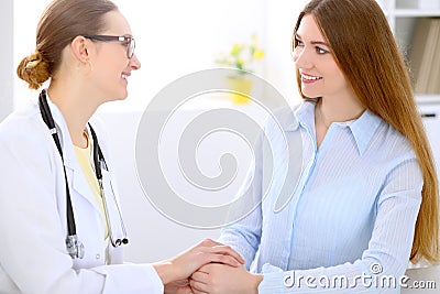 Doctor and patient sitting at the desk near window Stock Photo