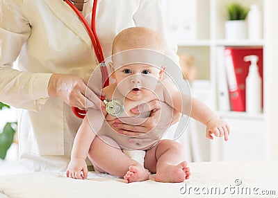 Doctor pediatric examining little baby in clinic. Baby health concept Stock Photo