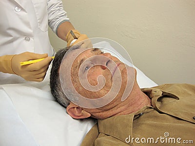 Doctor Performing Medical Procedure Stock Photo