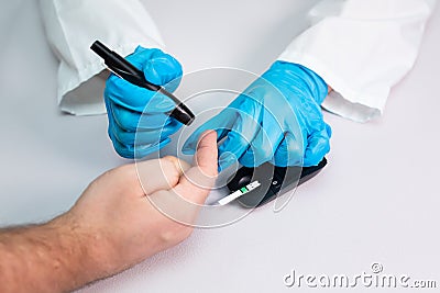 Doctor piercing patients finger with lancet in clinic closeup. Blood glucose control concept Stock Photo