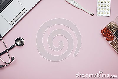 Doctor pink desk table with stethoscope, medicine, notebook. Top view with copy space, flat lay. Stock Photo