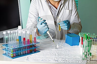 Doctor pipetting sample for study in petri dish Stock Photo