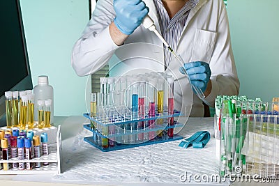 Doctor pipetting sample for study in tube Stock Photo