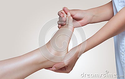 The doctor-podiatrist does an examination and massage of the patient`s foot Stock Photo