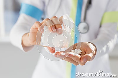 Doctor pouring medicine pills in hand Stock Photo