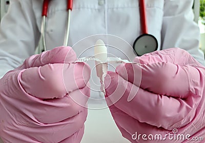 Doctor proctologist holding in hands antiinflammatory suppository for hemorrhoids closeup Stock Photo