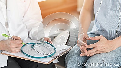 Doctor or psychiatrist consulting and diagnostic examining stressful woman patient on obstetric - gynecological female illness Stock Photo