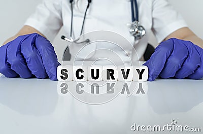 The doctor put together a word from cubes SCURVY Stock Photo