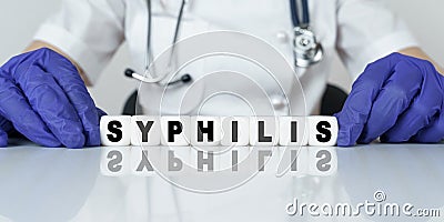 The doctor put together a word from cubes SYPHILIS Stock Photo