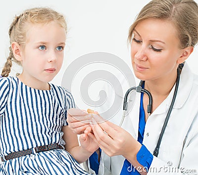 Doctor puts adhesive bandage. Stock Photo