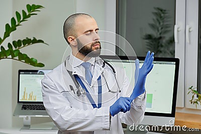 A doctor putting on a disposable medical glove preparing to examine a patient Stock Photo