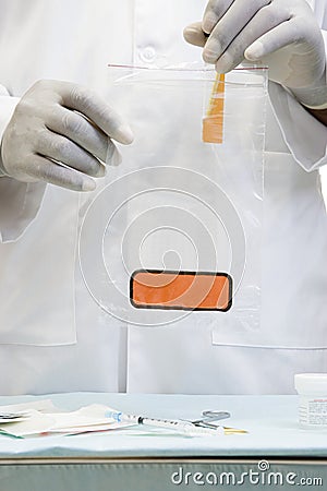 Doctor putting a sample in biohazard bag Stock Photo