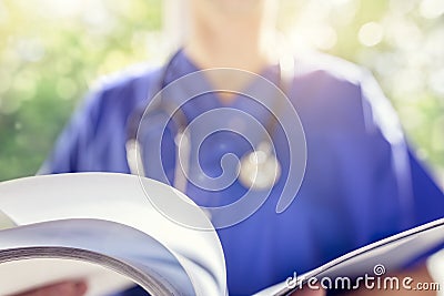 Doctor reading patient notes or medical chart Stock Photo