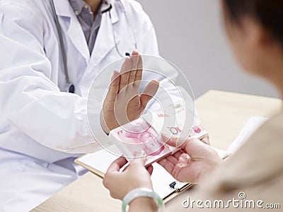 Doctor refusing kickbacks Stock Photo