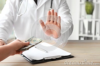 Doctor refusing to take bribe. Corruption concept Stock Photo