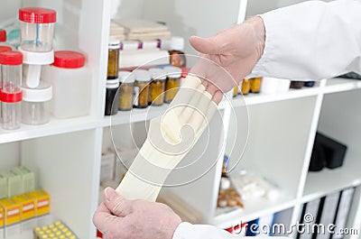 Doctor removing a latex glove Stock Photo