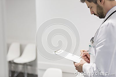 Doctor reviewing medical report at hospital Stock Photo