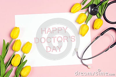 Doctor`s day greeting card with yellow tulips and stethoscope on pink background Stock Photo