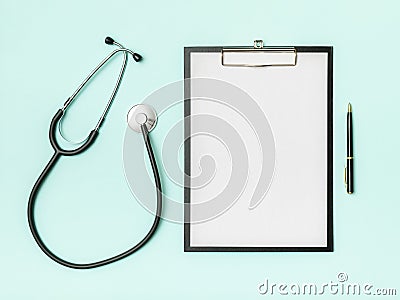 Doctor`s desk top view. Stethoscope and notebook on a colored background Stock Photo