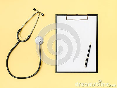 Doctor`s desk top view. Stethoscope and notebook on a colored background Stock Photo