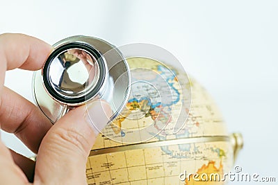 Doctor`s hand holding stethoscope inspecting on globe with China map on white background using as ecology world environment or Stock Photo