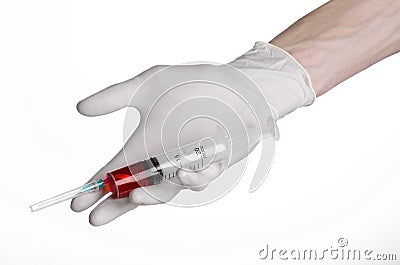 Doctor's hand holding a syringe, white gloved hand, a large syringe, the doctor makes an injection, white background Stock Photo