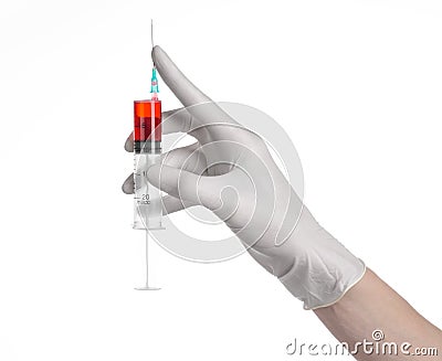 Doctor's hand holding a syringe, white gloved hand, a large syringe, the doctor makes an injection, white background Stock Photo