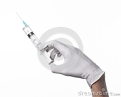 Doctor's hand holding a syringe, white-gloved hand, a large syringe, medical issue, the doctor makes an injection Stock Photo