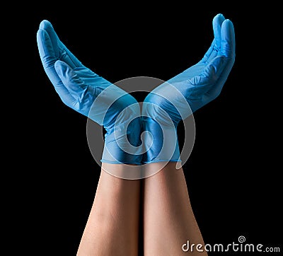 Doctor`s hand in sterile medical gloves hold earth shape isolated on black Stock Photo