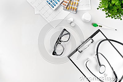 Doctor`s office desk with medical documents, charts, eyeglasses and stethoscope. Top view. Copy space Stock Photo