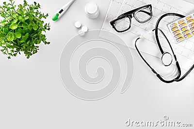 Doctor`s office desk with medical documents, charts, eyeglasses and stethoscope. Top view. Copy space Stock Photo