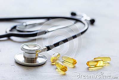 Doctor`s office table with pills and stethoscope white background Stock Photo