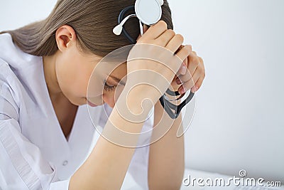 Doctor. Sad or crying female nurse at hospital office Stock Photo